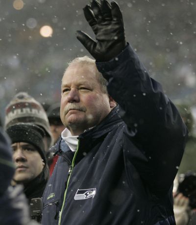 Mike Holmgren waves to the fans as he rounds the stadium after Sunday’s win. (Associated Press / The Spokesman-Review)