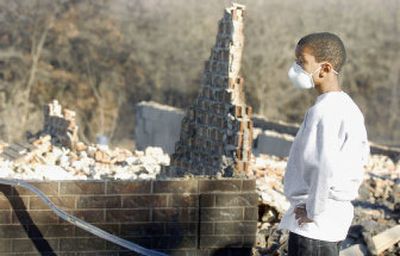 
Cameron Batson, 10, looks over his grandparents' burned-out house in Oklahoma City on Monday. 
 (Associated Press / The Spokesman-Review)