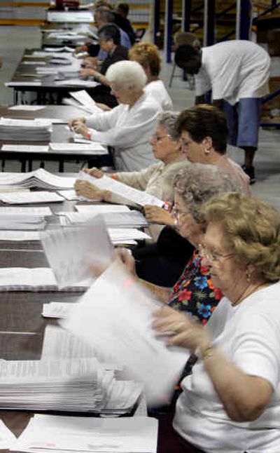 
A record number of absentee ballots are sorted at the Palm Beach County supervisor of elections office Friday.  More than 20,000 absentee ballots have been sent in for Tuesday's primary. 
 (Associated Press / The Spokesman-Review)