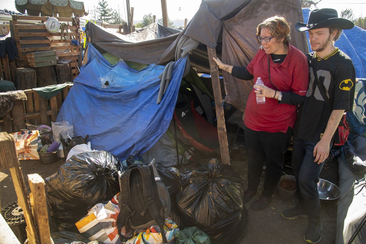 Kristen Gerloff and her boyfriend, Steven, stand by their tent Friday in Camp Hope. The couple is preparing to move into a downtown apartment.  (Jesse Tinsley/The Spokesman-Review)