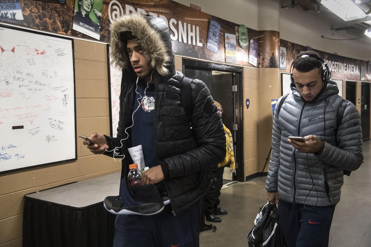 Gonzaga players Jeremy Jones, left, and Nigel Wiliams-Goss are bundled up from the cold as they enter Bridgetone Arena to face Tennessee Dec. 18, 2016, in Nashville, Tenn. (Dan Pelle / The Spokesman-Review)