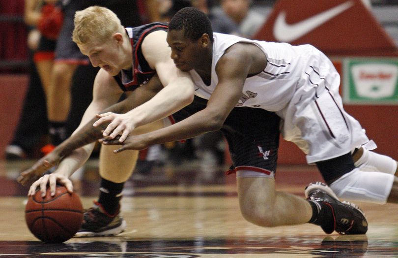EWU’s Bogdan Bliznyuk, left, steals ball from UM’s Mario Dunn. (Associated Press)