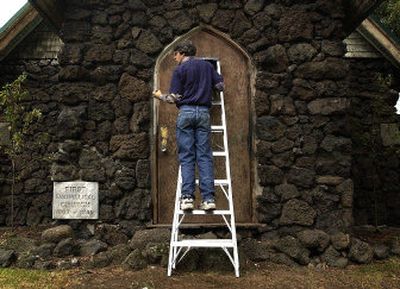 
Kelly Lordan paints the entrance to the Lighthouse Tabernacle on Saturday. 
 (The Spokesman-Review)