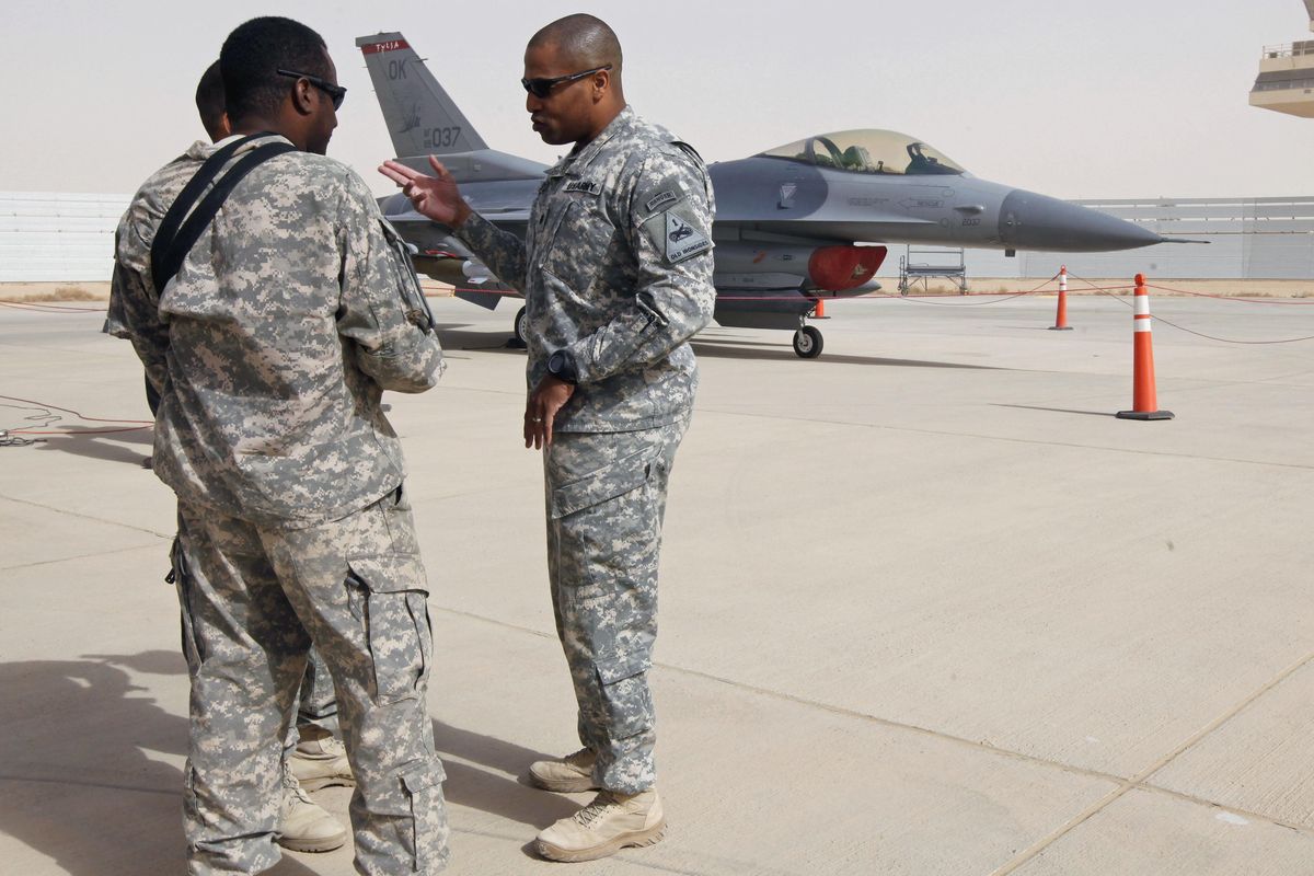 U.S. soldiers stand on the tarmac near AN F16 jet at al-Asad Air Base west of Baghdad, Iraq, Tuesday, Nov. 8 , 2011. Iran state TV says Tehran has launched “tens” of surface-to-surface missiles at Iraq’s Ain Assad air base housing U.S. troops over America’s killing of a top Iranian general. (Hadi Mizban / ASSOCIATED PRESS)