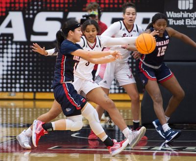 Gonzaga's Kayleigh Truong (11) works around the perimeter while being guarded by Eastern Eagle defender Britt Van Buren Tuesday, Dec. 21, 2021 in a non-conference game between EWU and Gonzaga. Gonzaga triumphed over the Eagles 76-48.  (JESSE TINSLEY/THE SPOKESMAN-REVIEW)