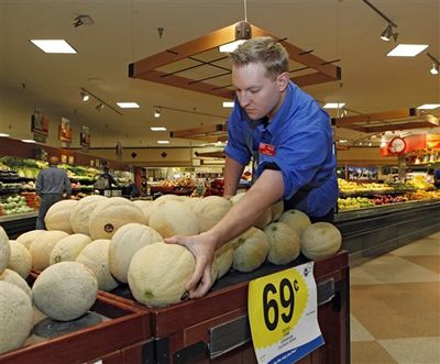 Produce manager Nate Codina arranges a display of Rocky Ford cantaloupes at a Denver Kings Soopers market on Friday, July 13, 2012. Colorado cantaloupes are back in supermarkets Friday, and growers of the Rocky Ford melons are going on the offensive to restore the fruit's reputation a year after Colorado melons caused a deadly nationwide listeria outbreak. Farmers have banded together to trademark the melons and fund a new tracking system to prevent future outbreaks. (Ed Andrieski / AP Photo)