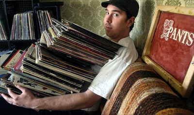 James Singleton (cq) holds a pile of records in his apartment music studio Oct. 17, 2006.  Singleton, known in the music world as James Pants, will headline a masquerade ball Oct. 27 at RAW Sushi and Island Grill.  HOLLY PICKETT The Spokesman-Review (Holly Pickett / The Spokesman-Review)