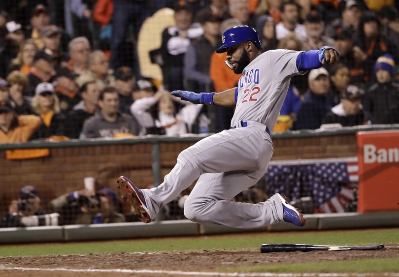 Chicago Cubs’ Jason Heyward scores against the San Francisco Giants during the ninth inning of Game 4 of baseball’s National League Division Series in San Francisco on Tuesday. (Marcio Jose Sanchez / Associated Press)