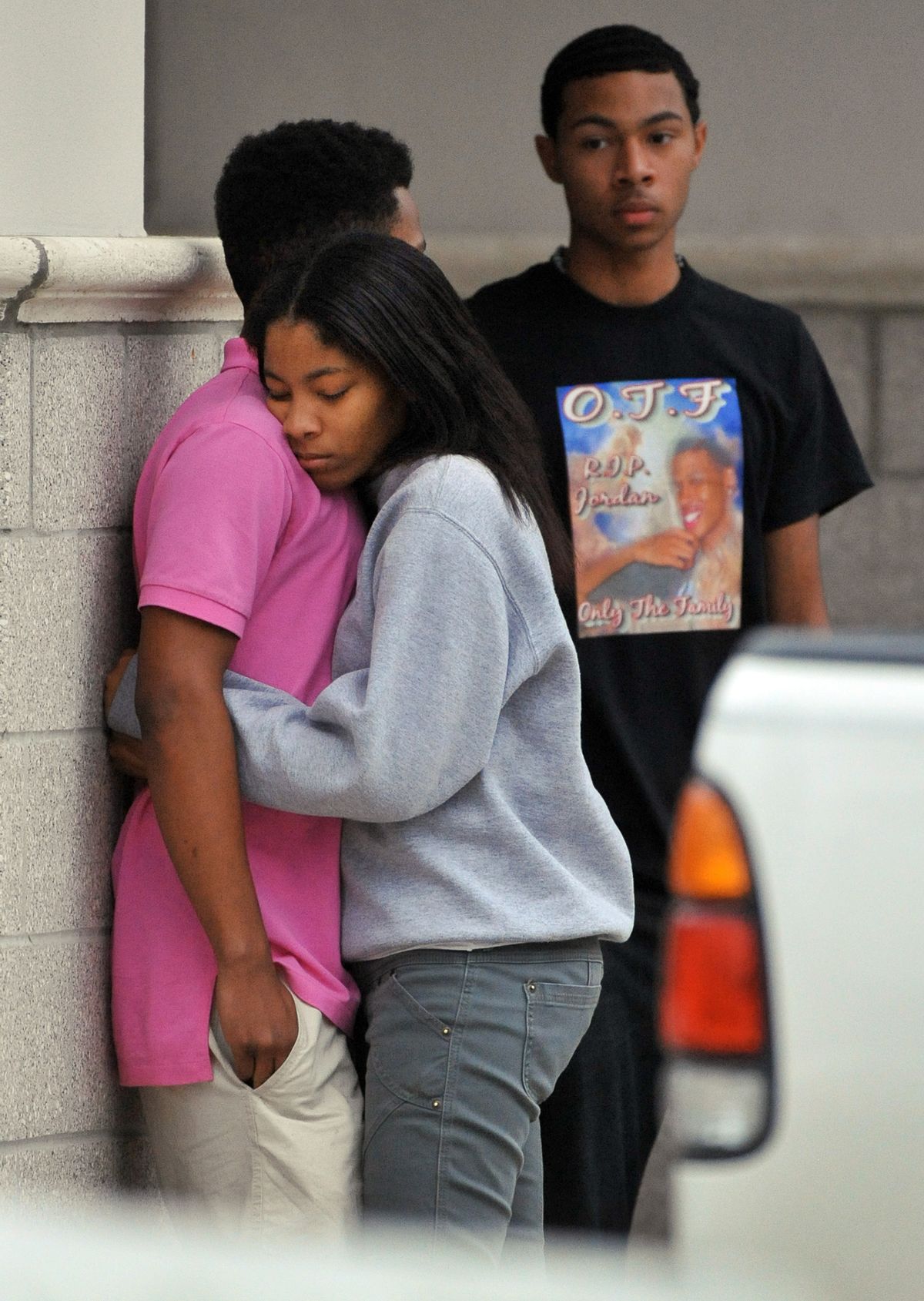 Friends of Jordan Davis comfort each other outside the funeral home where the visitation with Davis