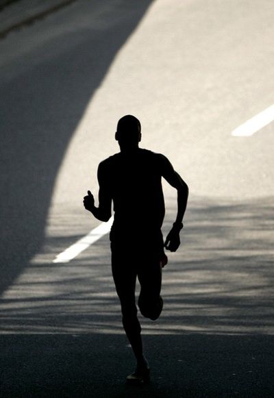 Robert Cheruiyot, of Kenya, is silhouetted as he runs under a traffic bridge with less than a mile to go in the 112th running of the 26.2 mile Boston Marathon in Boston, Monday, April 21, 2008. Cheruiyot went on to win the race with a time of 2:07:46. (AP Photo/Steven Senne) ORG XMIT: MASR103 (Steven Senne / The Spokesman-Review)