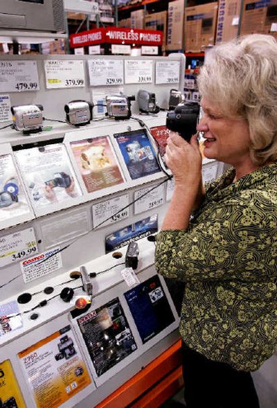 
Costco shopper Cindy Watten looks at a digital camera at a camera display at a Costco store in Mountain View, Calif., A Consumer Reports survey lists online sites as the best place to shop for electronics. Costco has the best return policy of the retailers in Consumer Reports survey. Consumer Reports also says that when low price matters most, Amazon.com, Costco.com, J&R.com, Costco, and BJs Wholesale are good choices. 
 (Associated Press / The Spokesman-Review)