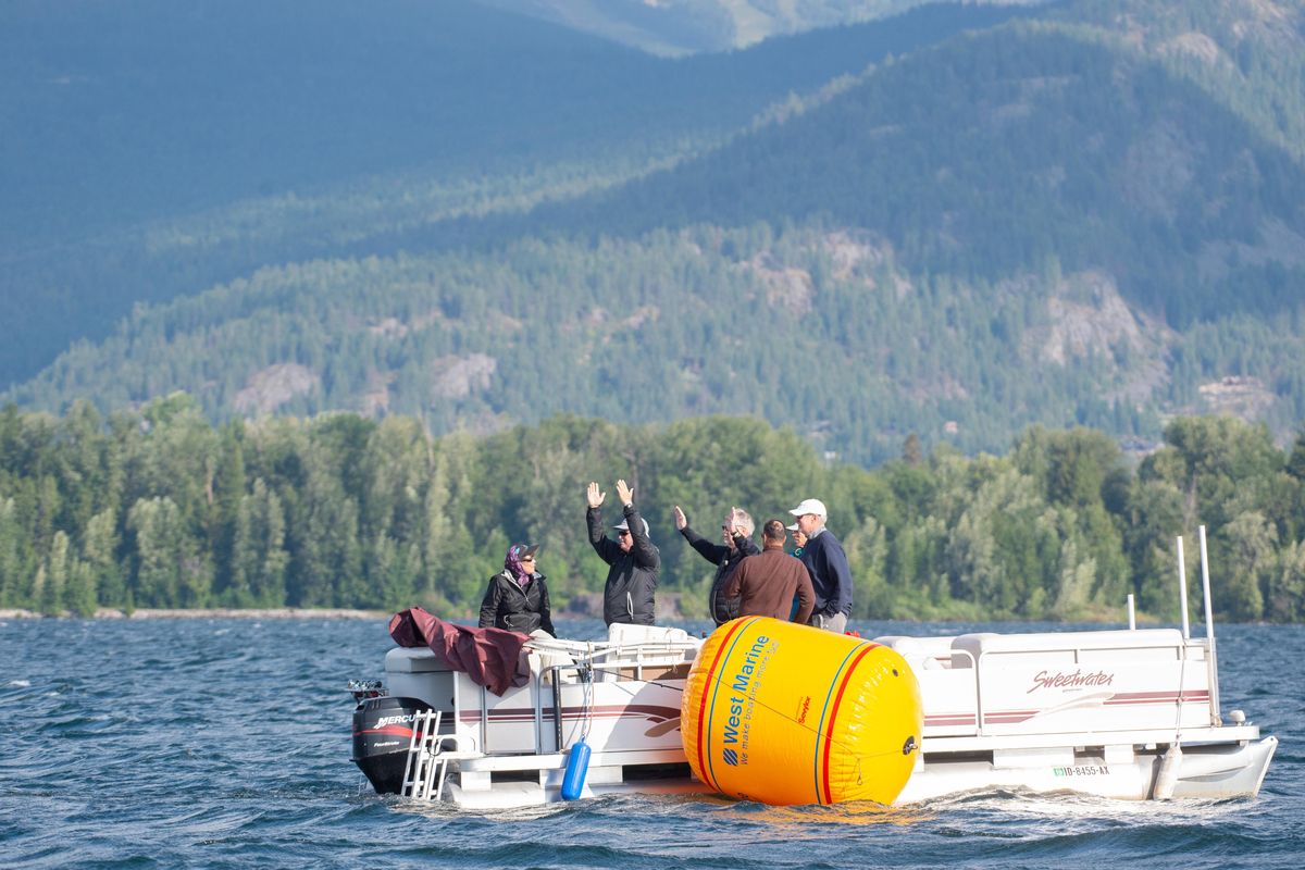 Members of the race committee at the Thistle National Championships assess the wind direction before races start on Lake Pend Oreille Wednesday, July 24, 2019. Thistle owners from around the nation have gathering in Sandpoint, Idaho for a week of races to decide the national championships. The boat is general sailed by a group of three people, often by family members and longtime friends. Jesse Tinsley/THE SPOKESMAN-REVIEW (Jesse Tinsley / The Spokesman-Review)