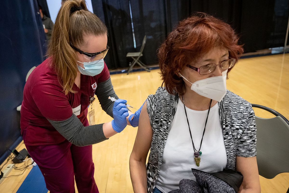 Eiko Matsunaga receives her first dose of the Moderna COVID-19 vaccine Friday from WSU nursing student Jennifer Kabat at a Chas Health vaccination clinic set up in Gonzaga’s Martin Centre. (COLIN MULVANY/THE SPOKESMAN-REVIEW)