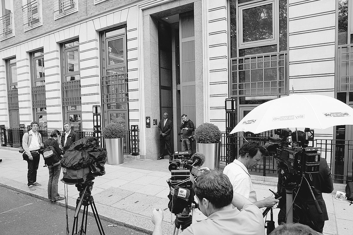 Members of the media gather outside BP headquarters in London on Monday. Shares in BP PLC plunged again on Monday as the company