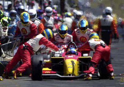 
Pit crew members refuel the car for French driver Sebastien Bourdais during the Champ Car Grand Prix of Portland on Sunday.  
 (Associated Press / The Spokesman-Review)