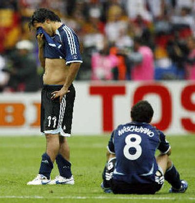 
Carlos Tevez  and Javier Mascherano react after Argentina's shootout loss to Germany. 
 (Associated Press / The Spokesman-Review)