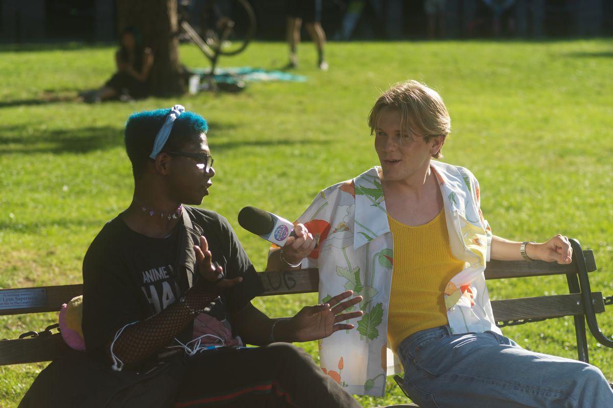 Davis Burleson, right, a New School dropout who has more than 2 million followers on TikTok, during an interview for his person-on-the-street show, "What