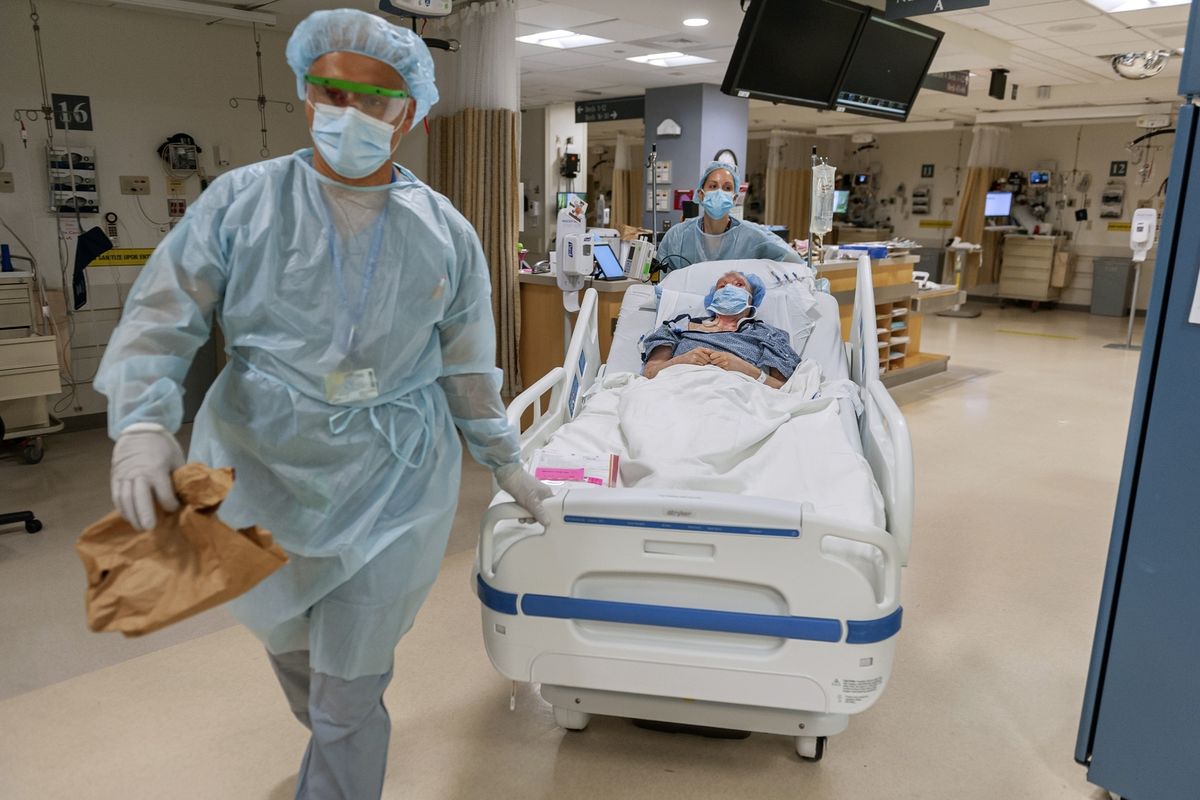 Members of the Brigham and Women’s Hospital’s transplant anesthesiology team, Drs. Kamen V. Vlassakov front, and Lindsay Wahl lead Carmen Blandin Tarleton to the operating room for her second face transplant at the Boston hospital. She is healing and expected to resume her normal routine.  (J. Kiely Jr./Lightchaser Photography)