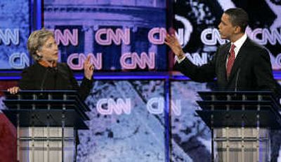 
Sen. Hillary Rodham Clinton and Sen. Barack Obama confront one another at Monday's Democratic presidential debate in Myrtle Beach, S.C. Former Sen. John Edwards, below, also participated.
 (Associated Press photos / The Spokesman-Review)
