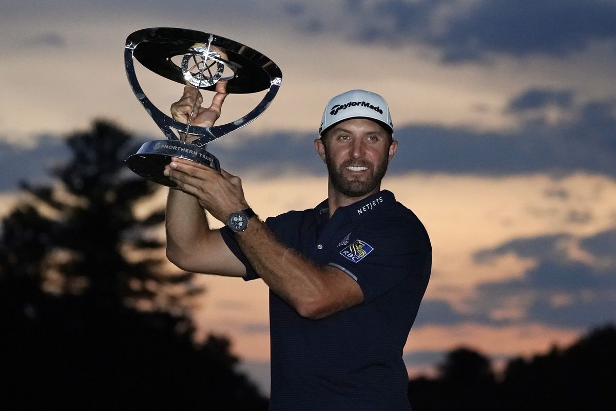 Dustin Johnson holds the trophy after winning the Northern Trust golf tournament at TPC Boston, Sunday, Aug. 23, 2020, in Norton, Mass.  (Charles Krupa)