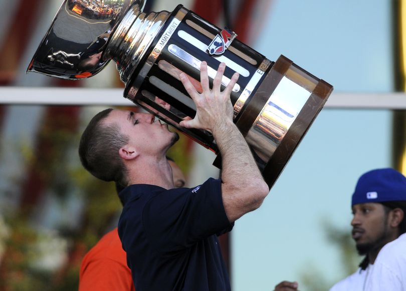 Quarterback Kyle Rowley, hoists the 2010 Arena Bowl trophy and plants a kiss on it during a rally for the Spokane Shock, Arena Football champions, on Wednesday, Aug. 25, 2010, outside the Spokane Arena. (Jesse Tinsley / The Spokesman-Review)