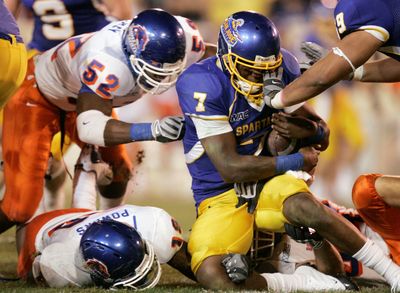 Boise State’s Derrell Acrey (52) sacks San Jose State quarterback Kyle Reed in the first half. (Associated Press / The Spokesman-Review)