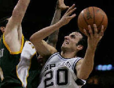 
San Antonio guard Manu Ginobili drives to the basket against the SuperSonics' Nick Collison. 
 (Associated Press / The Spokesman-Review)