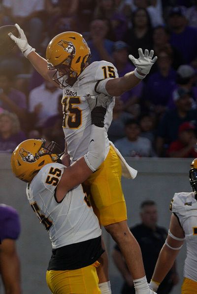 Idaho lineman Jack Foster, left, lifts up wide receiver Mark Hamper in celebration during a win over Abilene Christian on Saturday in Abilene, Texas.  (Courtesy of Idaho Athletics)