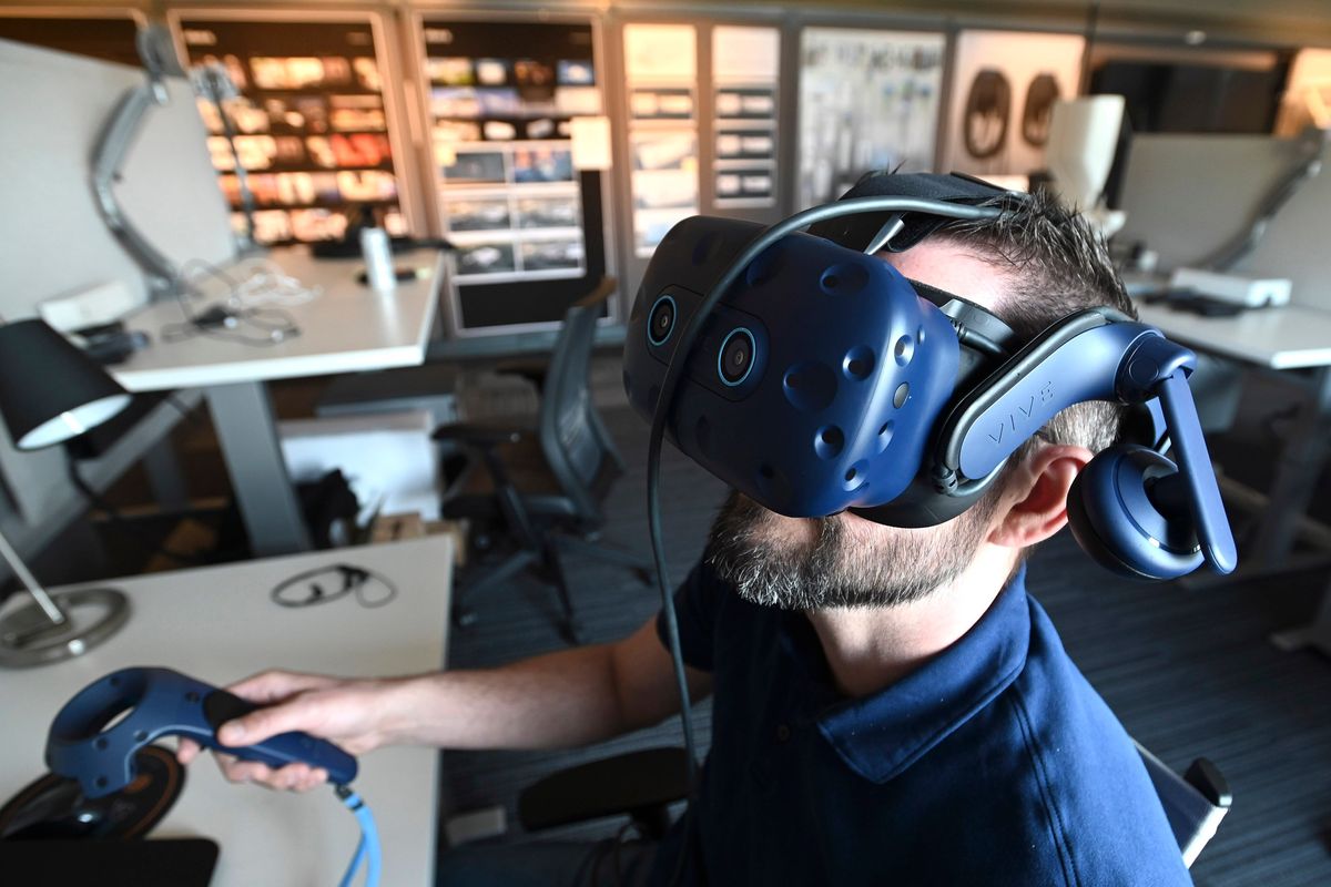 Design technical expert John Michie wears a virtual reality headset as he views product designs at General Motors Co.’s Global Technical Center on April 11.  (Detroit News)