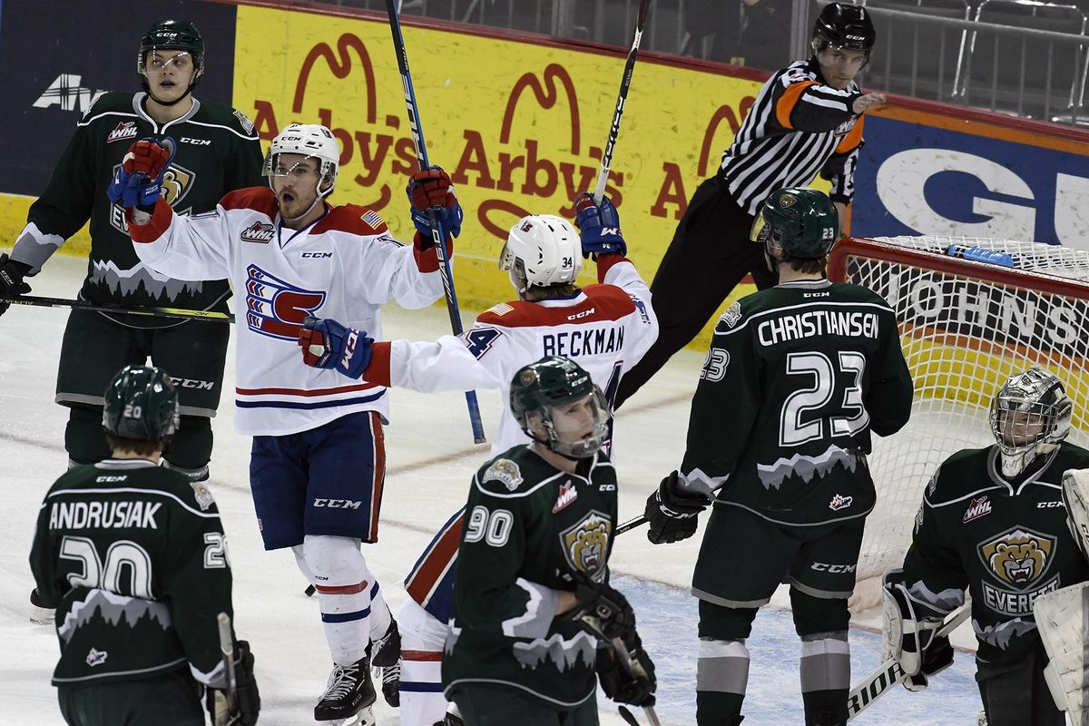 Spokane forward Ethan McIndoe (on left in white) celebrates the Chiefs first goal of the night against Everett during the first period of an WHL playoff game, Wed., April 10, 2019, in the Spokane Arena. (Colin Mulvany / The Spokesman-Review)