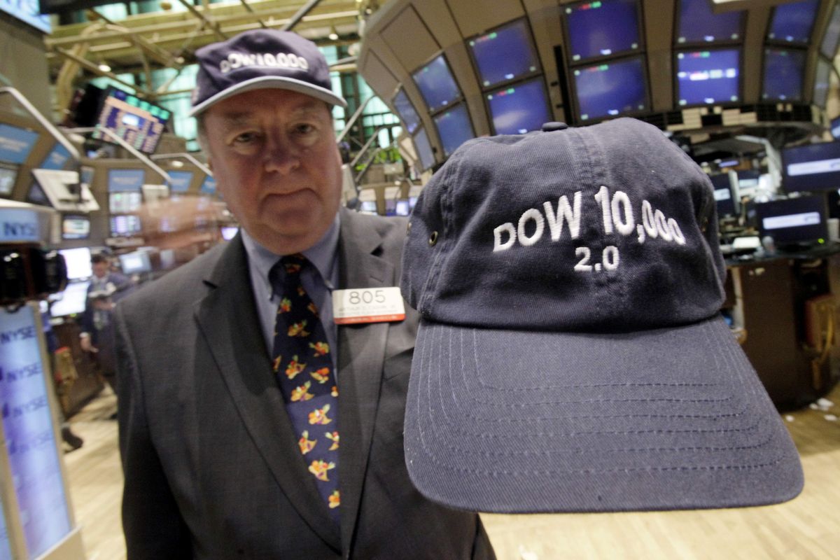 Arthur Cashin, director of floor operations for UBS Financial Services, wears his 1999 “Dow 10,000” cap, while holding the 2009 “2.0” version, Wednesday on the floor of the New York Stock Exchange. Associated Press photos (Associated Press photos / The Spokesman-Review)