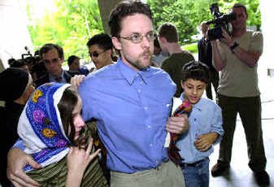 
Brandon Mayfield walks arm-in-arm with his daughter Sharia Mayfield, 12, left, and his son Famir Mayfield, 10, outside the federal courthouse Thursday in Portland after he was released from custody. Brandon Mayfield walks arm-in-arm with his daughter Sharia Mayfield, 12, left, and his son Famir Mayfield, 10, outside the federal courthouse Thursday in Portland after he was released from custody. 
 (Associated PressAssociated Press / The Spokesman-Review)