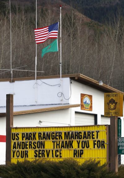 Flags fly at half staff in honor of Mount Rainer National Park Ranger Margaret Anderson at a fire station Tuesday in Ashford, Wash. (Associated Press)