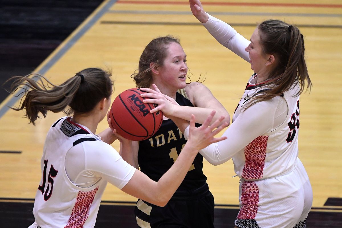 Eastern Washington’s Maisie Burnham, left, and Grace Kirscher pressure Idaho guard Rylee Alexander on Thursday night in Cheney.  (Colin Mulvany/THE SPOKESMAN-REVIEW)