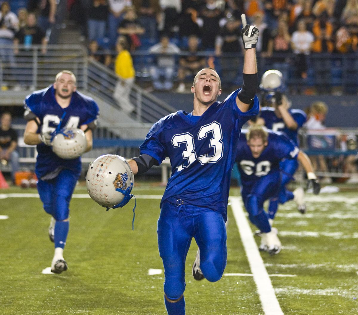 Garrett Blauert, after rushing for 295 yards, leads the celebration.  (Associated Press / The Spokesman-Review)