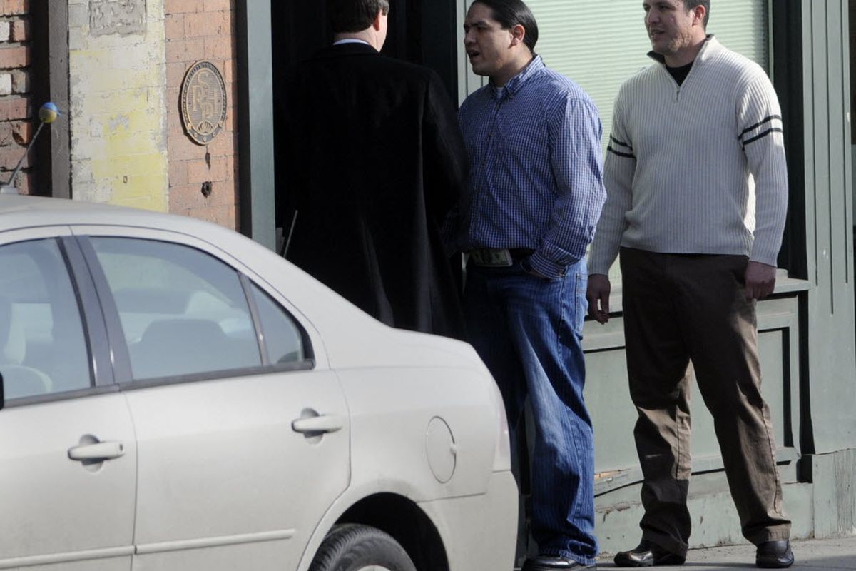 Shonto Pete, center, the man shot by Spokane Police officer James "Jay"  Olsen, exchanges heated words with Robert Cossey,  Olsen