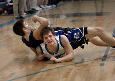 
Coeur d'Alene's Jake Wolfe lands on top of Lake City's Ben Widmyer on Tuesday. Widmyer drew a foul on the play. 
 (Tom Davenport/ / The Spokesman-Review)