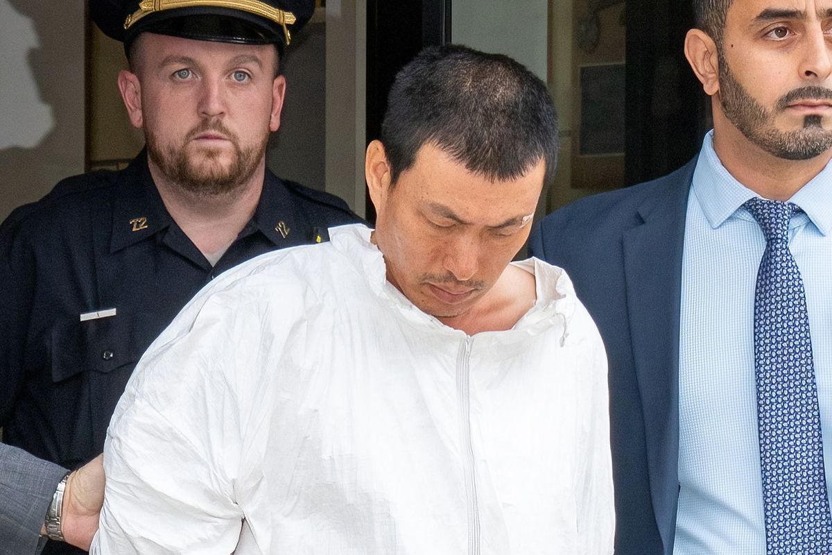 Liyong Ye, the suspect in a deadly hammer attack in Brooklyn a day earlier, is pictured in police custody outside the NYPD’s 72nd Precinct station house on Thursday.  (Theodore Parisienne/New York Daily News/TNS)