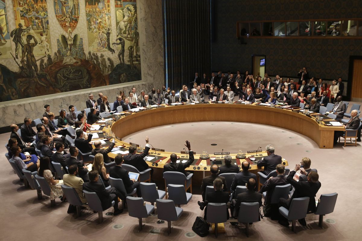 FILE - In this July 20, 2015, file photo, members of the Security Council vote at United Nations headquarters on the landmark nuclear deal between Iran and six world powers. The United States is planning a new diplomatic line of attack on Iran after a resounding defeat in the U.N. Security Council. Having lost its long-shot bid to indefinitely extend an international arms embargo on Iran last week, the Trump administration is poised to call for the re-imposition of all U.N. sanctions that had been eased under the 2015 nuclear deal from which the U.S. withdrew two years ago.  (Seth Wenig)