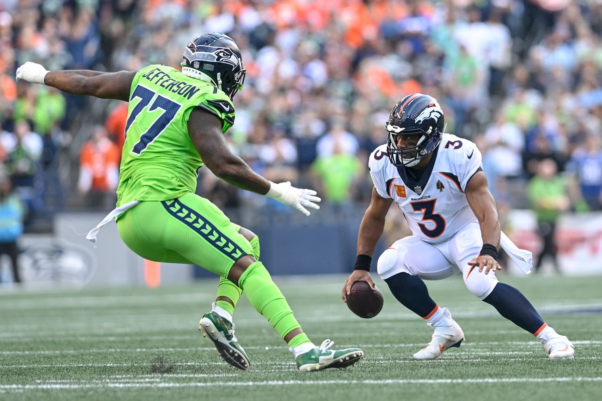 Russell Wilson (3) of the Denver Broncos scrambles as Quinton Jefferson (77) of the Seattle Seahawks pressures during the first quarter at Lumen Field on Monday, Sept. 12, 2022. (Photo by AAron Ontiveroz/The Denver Post)  (AAron Ontiveroz)