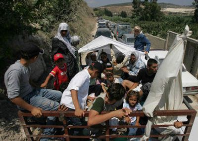 
Lebanese villagers on a pickup truck are stuck in a traffic jam as they flee to the north of the country on Monday. 
 (Associated Press / The Spokesman-Review)