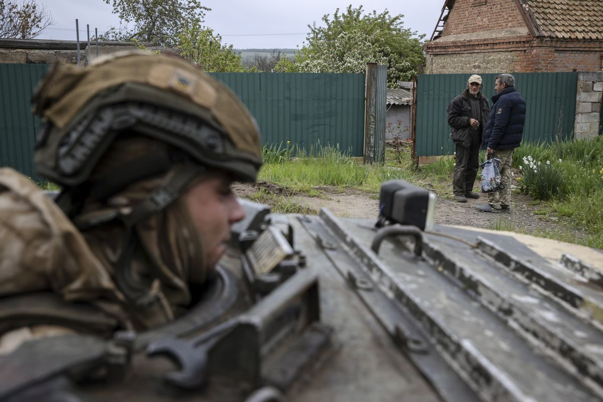 Members of the Ukrainian 28th Mechanized Brigade ride in a BMP armored vehicle during a mission to fire a SPG-9 recoilless gun at a Russian target in the direction of Bakhmut in eastern Ukraine, May 8, 2023. (Tyler Hicks/The New York Times)