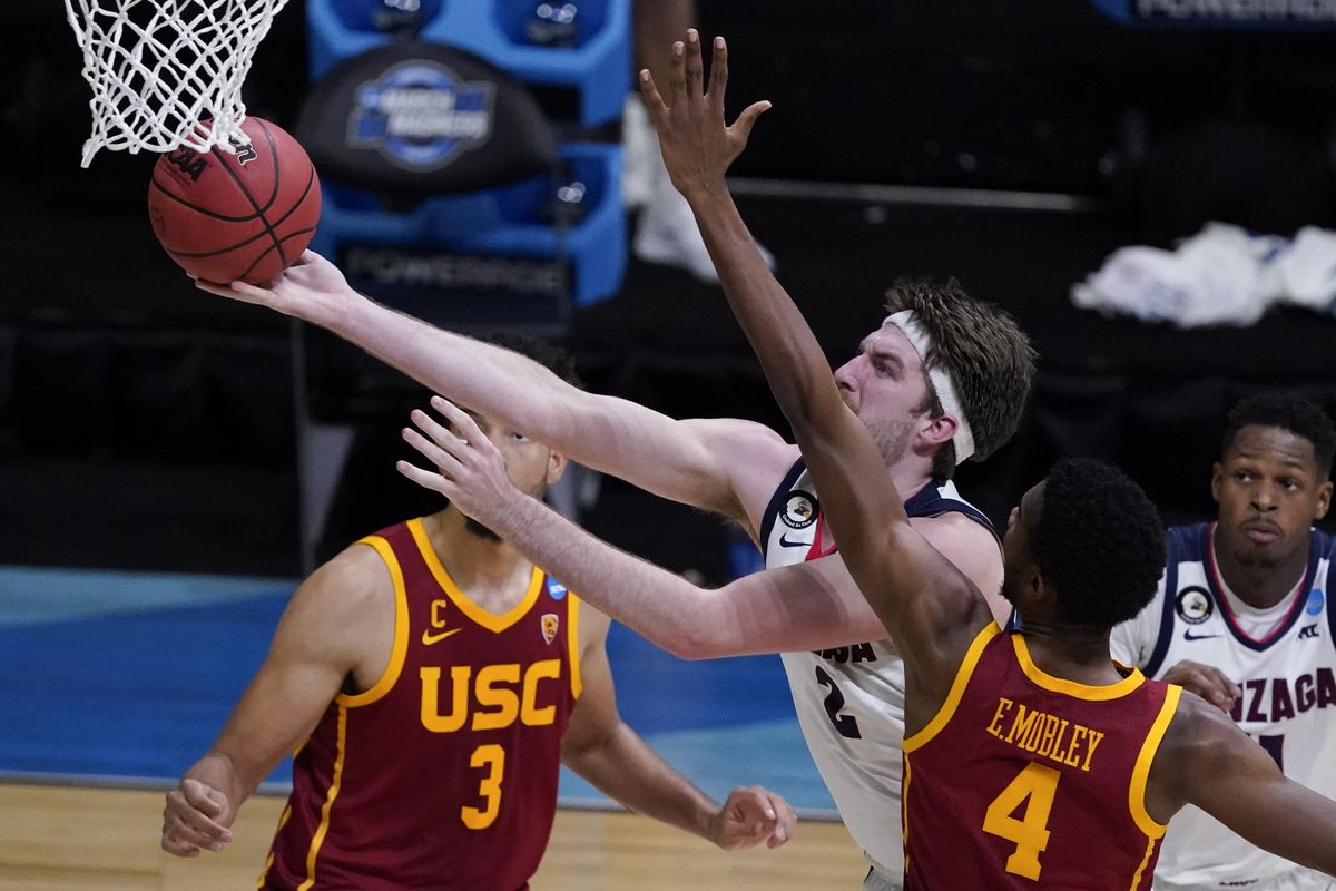 Gonzaga forward Drew Timme drives to the basket ahead of Southern California forward Evan Mobley (4) during the second half of an Elite 8 game in the NCAA men