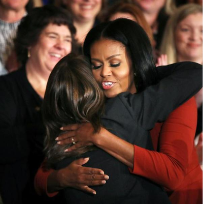 Counselor Jeralyn Mire can be seen in the background as Michelle Obama hugs 2017 School Counselor of the Year Terri Tchorzynski after her final speech as first lady at the 2017 School Counselor of the Year ceremony at the White House last Friday. (Manuel Balce Ceneta / AP)