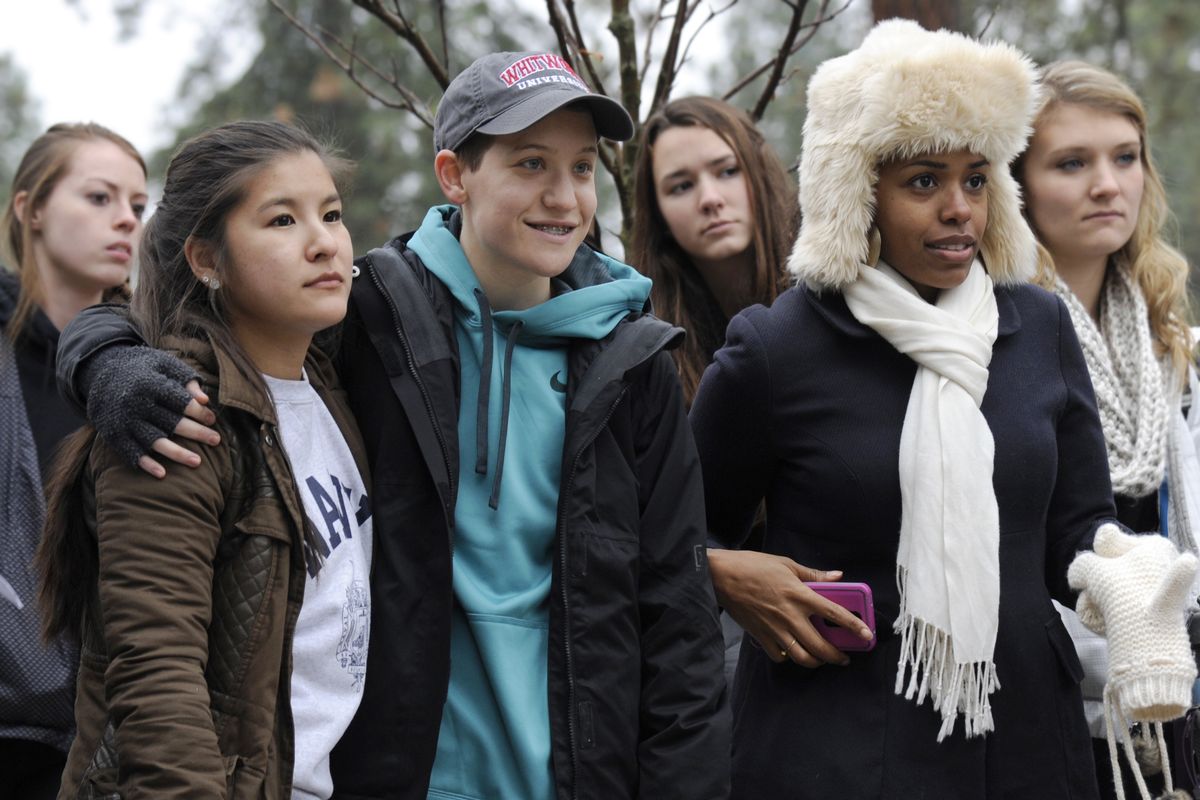 While other students speak, students at Whitworth University – including, from left, Camina Hirota (Navy sweatshirt), Ashton Skinner and Ahyana King – listen at a rally about issues of equality and racism Friday. (PHOTOS BY JESSE TINSLEY)