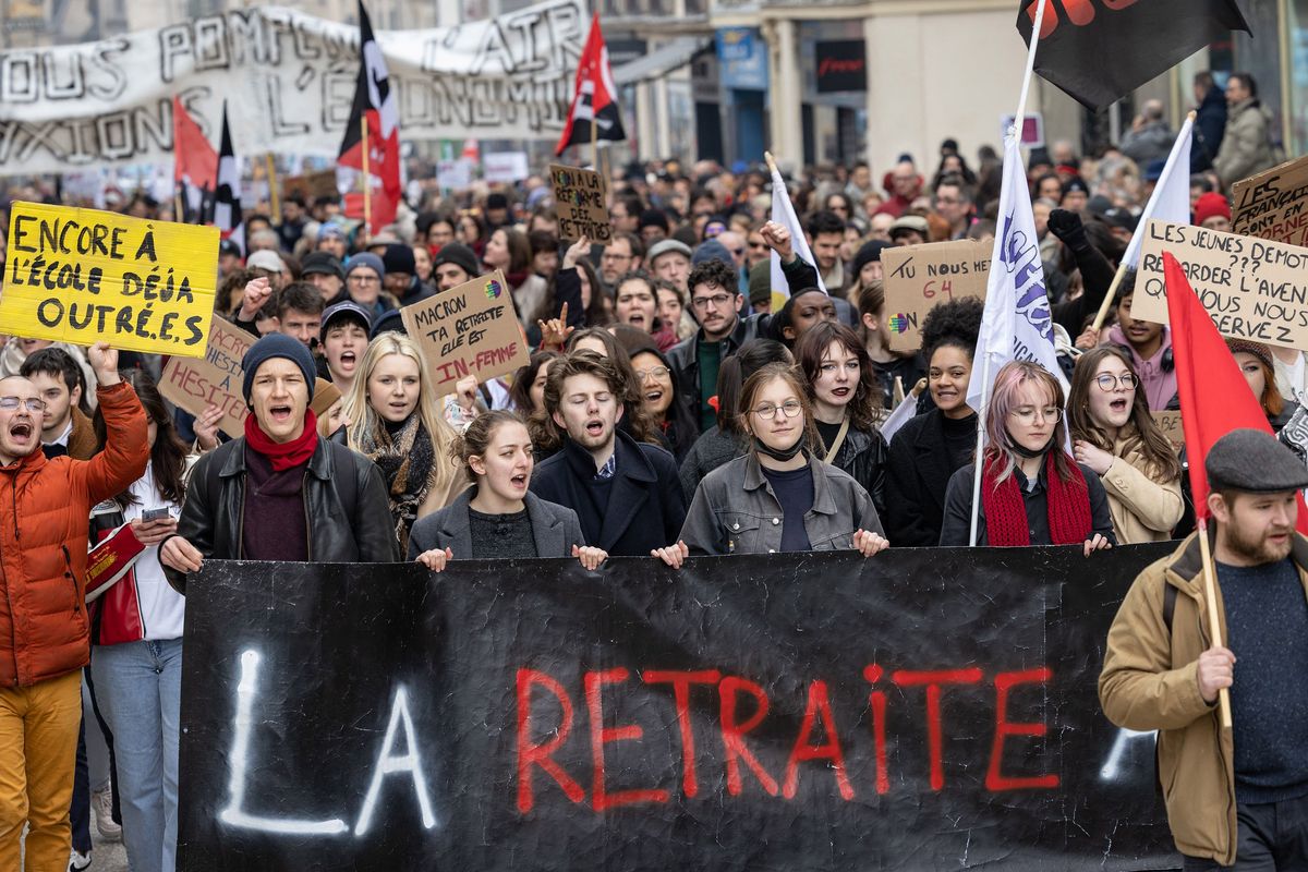 Protesters hold flags, placards and a banner reading "the retirement" in a demonstration in Dijon, central-eastern France on Tuesday, March 7, 2023, on the sixth day of nationwide rallies organized since the start of the year against French President