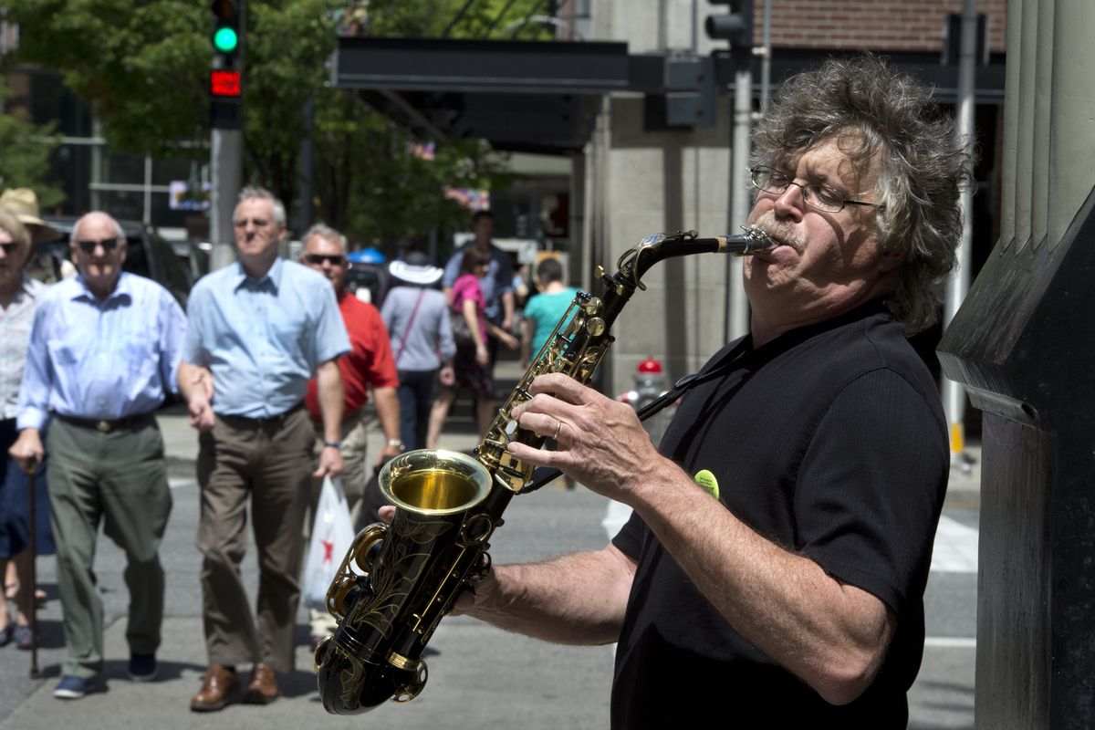 Charlie Butts plays his sax Monday at the corner of Riverside Avenue and Post Street for Street Music Week.
