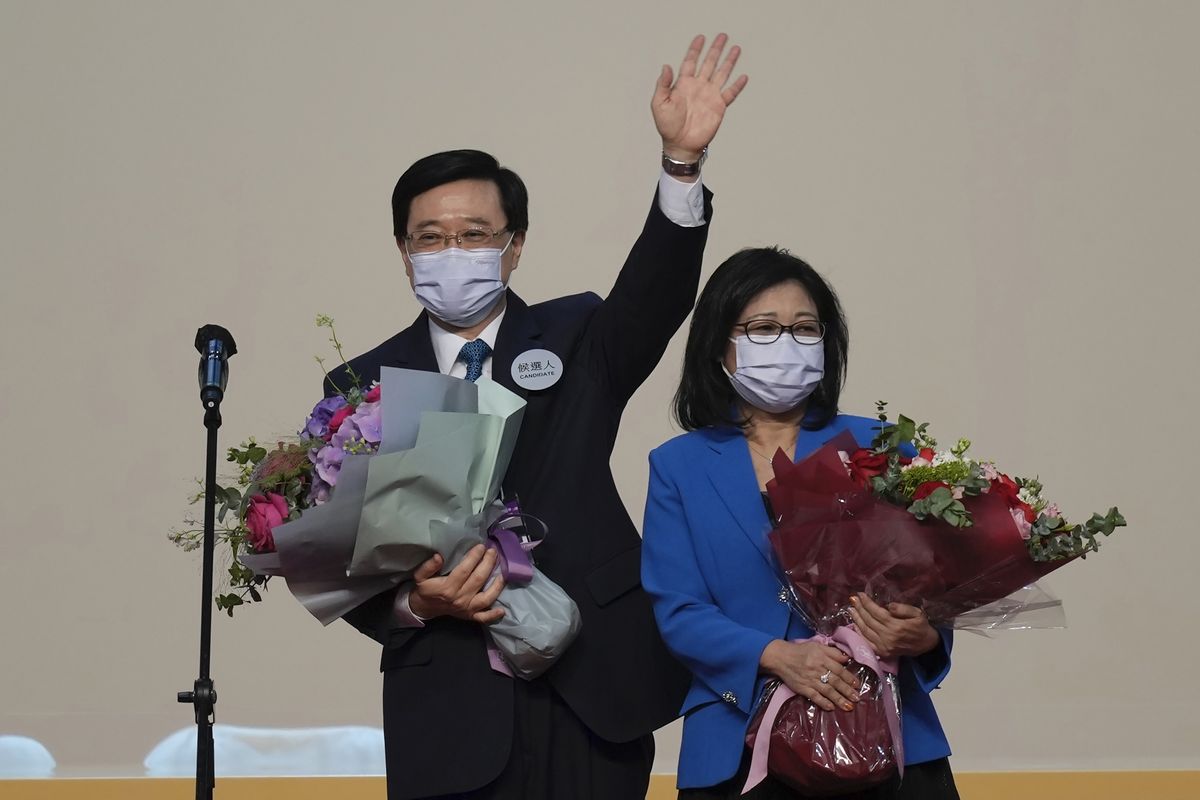 John Lee, former No. 2 official in Hong Kong and the only candidate for the city’s top job, celebrates with his wife after declaring his victory in the chief executive election of Hong Kong in Hong Kong on Sunday.  (Kin Cheung)