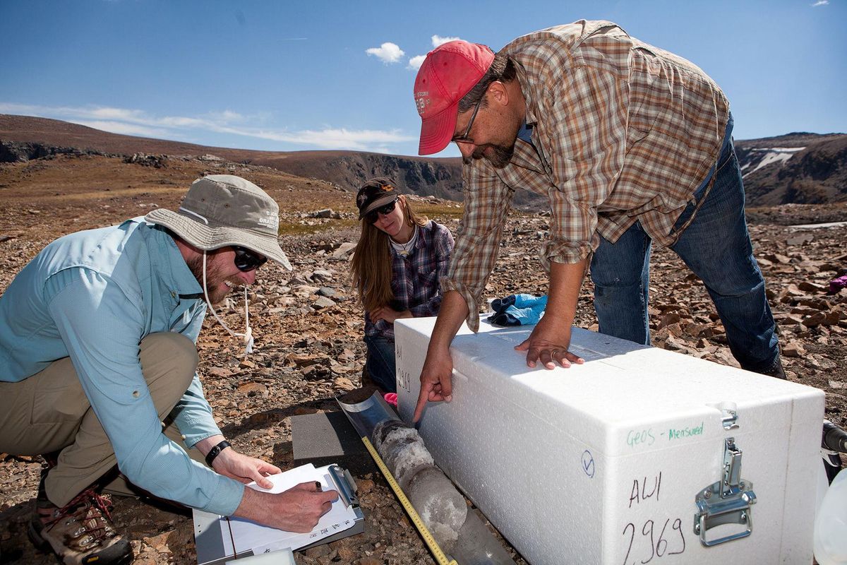 From left, Nathan Chellman and Montana State University anthropologist Sari Dersam and ice patch archaeologist Craig Lee collect an organic sample from an ice core in the Greater Yellowstone Area. (Matthew Stirn / Courtesy)