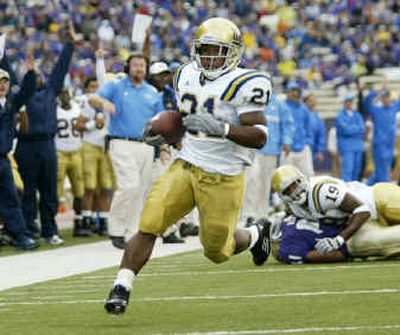 
UCLA tailback Maurice Drew ran all over the Huskies, piling up 322 yards and five touchdowns, including this one in the second quarter. The Bruins had 424 yards on the ground.
 (Associated Press / The Spokesman-Review)